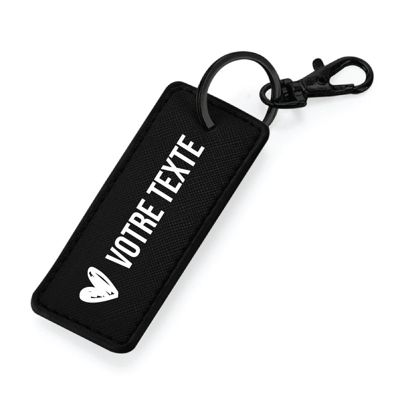 Porte-clés noir en simili cuir avec anneau métallique noir, finition élégante et message personnalisable.
