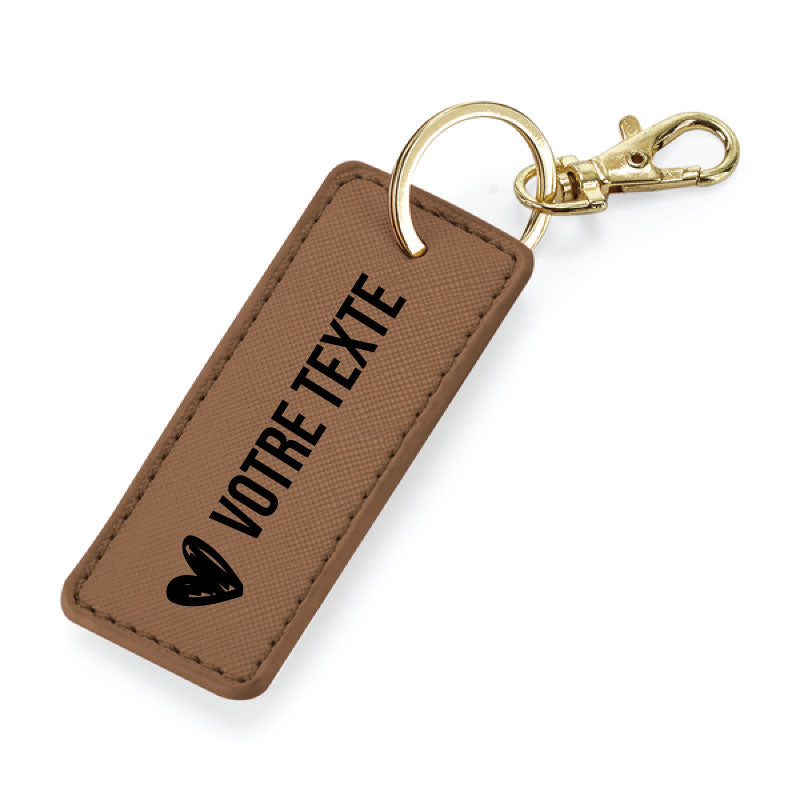 Porte-clés marron en simili cuir avec anneau métallique or, finition élégante et message personnalisable.