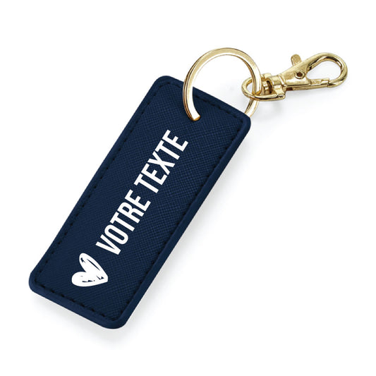 Porte-clés marine en simili cuir avec anneau métallique or, finition élégante et message personnalisable.